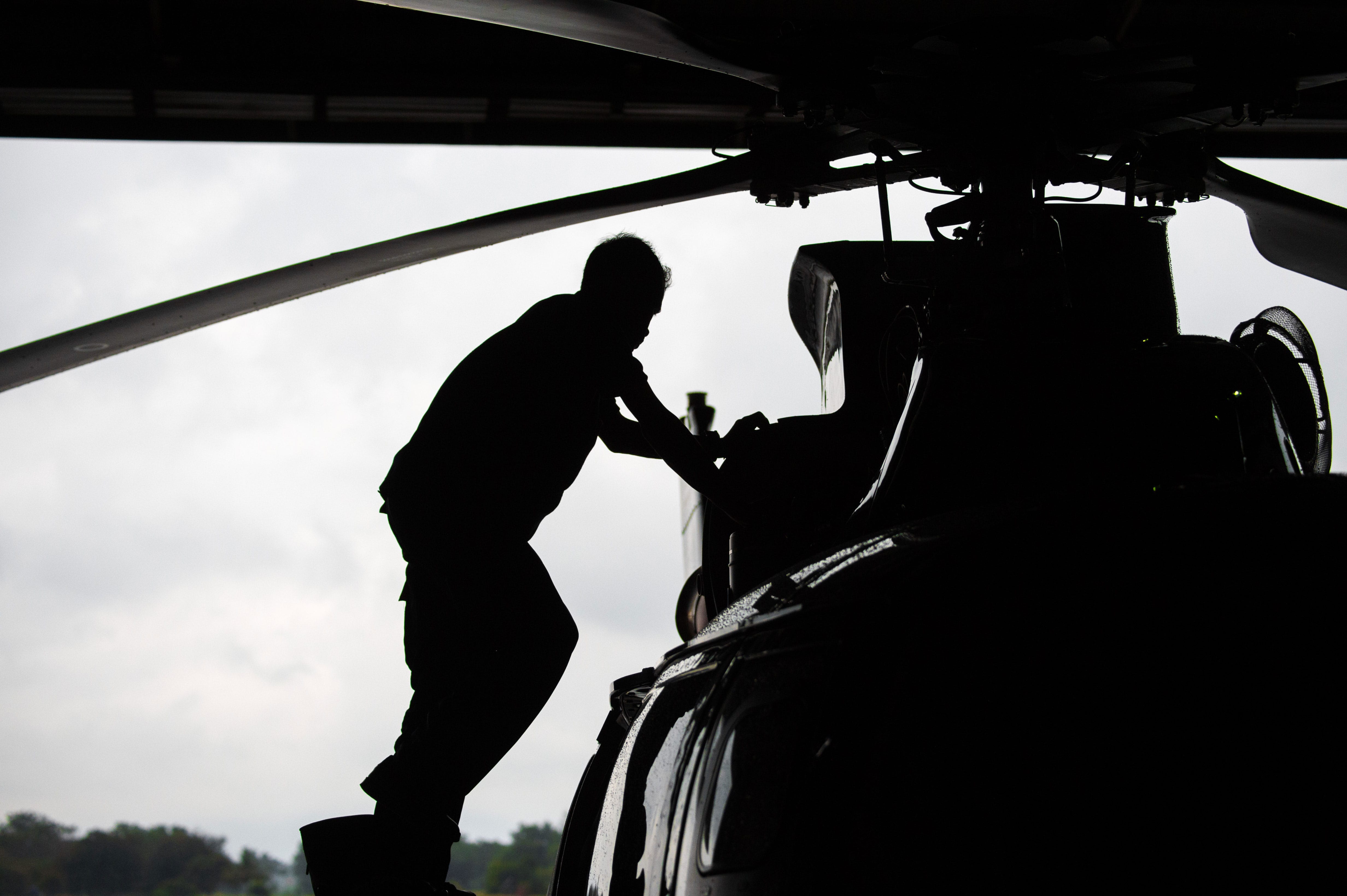 Man working on a helicopter